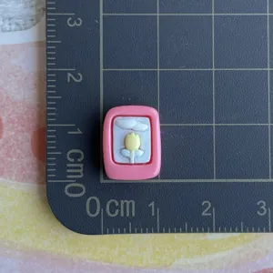Resin tulip charm detail shot, miniature DIY cabochon for phone case and hair clip decoration.