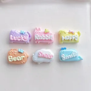 Detail view of colorful resin animal charms with cute embossed English words for DIY crafts.
