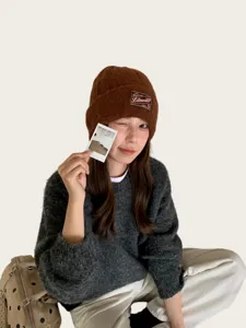 Brown knit beanie hat detail view, thick cozy wool cap winter warm headwear accessories.