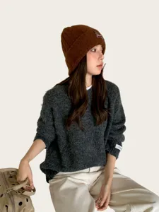 Brown knit beanie hat detail, winter warm wool cap, casual retro style fashion streetwear.