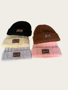 Detailed view of winter thick warm knitted beanie hat, soft wool material, retro patch style.