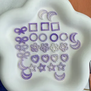 Detailed view of purple and white imitation pearl DIY craft charms in various shapes.