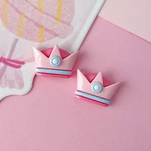 Glossy pink resin crown DIY accessories for hair clips, shoes, and handmade cream glue crafts.