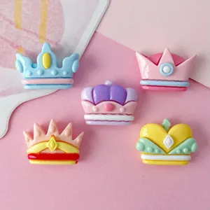 Close up of colorful resin crown charms for DIY craft, cute tiara cabochons details.