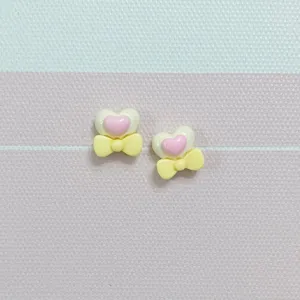 Mini heart bow resin charms, cute pink and yellow cabochons for nail art and DIY crafts.