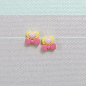 Resin heart bow charm detail shot for nail art and DIY hair clip decoration crafts.