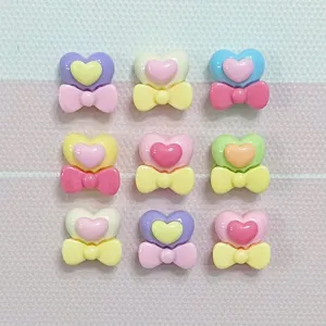 Mini resin heart bow charms, cute pastel DIY accessories for nail art and hair clips details.