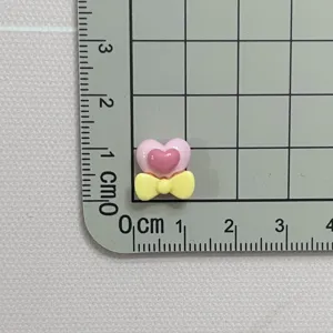 Mini resin heart bow charm flatback for nail art DIY crafting jewelry making decorations.