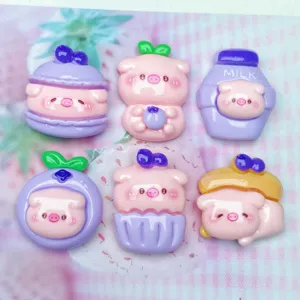Close up of cute purple blueberry pig resin cabochons for DIY phone case crafts and hair clips deco.