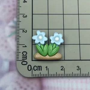 Resin flower cabochon detail view, cute blue floral craft accessory for DIY phone case decor.