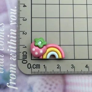 Resin strawberry rainbow charm detail view, cute DIY accessory for phone cases and hairpins.