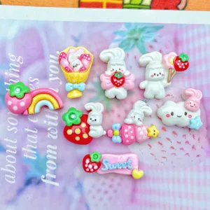 Cute resin cabochons with rabbit, strawberry and rainbow designs for DIY phone cases and hair clips.