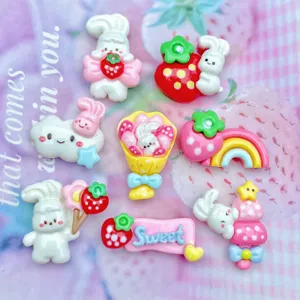Resin craft accessories detail showing cute cartoon bunnies and strawberries flatbacks charms.