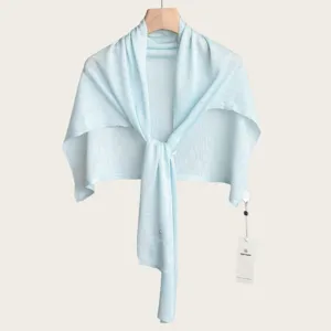 Light blue knit summer shawl detail, thin fabric, elegant shrug for air conditioning room.