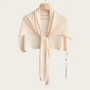 Detailed view of a lightweight knitted shawl, sheer fabric texture, elegant drape design.