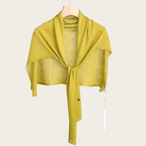 Close-up detail of the lightweight knitted T-shaped shawl, breathable summer fabric texture.
