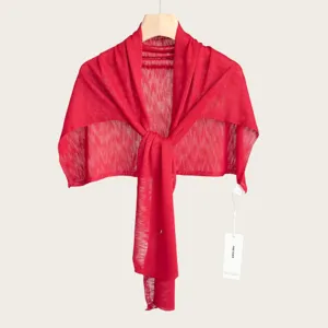 Detailed view of the red summer knitted shawl, lightweight texture and elegant drape.