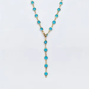 Gold-tone Y-shaped lariat necklace featuring vibrant blue bezel-set round glass stone stations.