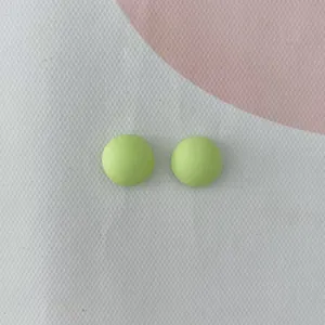 Primo piano dettagliato di cabochon rotondi in resina verde chiaro per fai da te e nail art.
