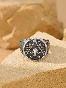 Macro view of vintage distressed stainless steel men's ring with skull and moon engraving