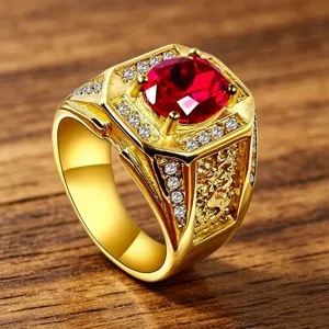 Close-up detail of luxury men's ring with red gemstone and vintage gold engraving