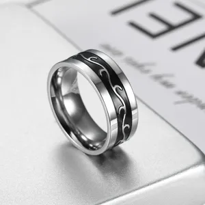 Polished stainless steel men's band ring featuring a unique black dragon pattern inlay