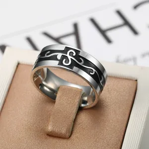 Men's stainless steel ring with black dragon scroll pattern on tan display stand