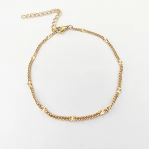 Stainless steel gold tone station necklace detail showcasing delicate star stations and lobster clasp.