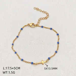 Stainless steel gold chain bracelet with blue beads and cross pendant, adjustable size.