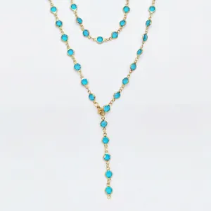 Gold stainless steel Y-chain necklace detail, blue round stone bezel set bohemian jewelry.