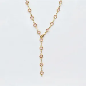 Stainless steel gold Y-chain necklace featuring sparkling pink glass stones for women.