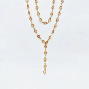 Gold stainless steel Y-shaped necklace detail featuring pink glass stones, elegant drop design.