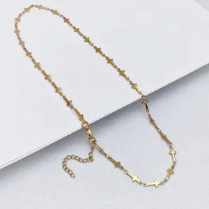 Stainless steel gold-colored cross chain detail, delicate necklace links and clasp features.