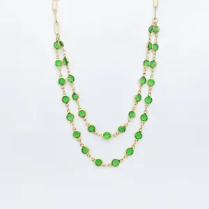 Gold-toned stainless steel double-layered necklace featuring vibrant green bezel-set crystal stones.