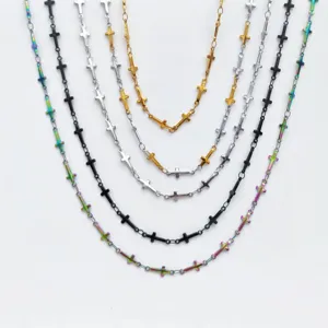 Detail view of multiple stainless steel cross necklaces in various colors, stylish fashion jewelry.