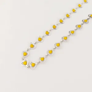 Stainless steel yellow enamel heart chain detail shot, minimalist design fashion jewelry necklace.