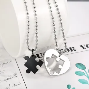 Detailed view of matching stainless steel heart puzzle necklaces with ball chains for couples