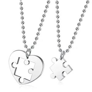 Detailed view of stainless steel heart and puzzle piece couple necklace pendants