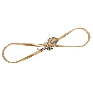 Gold elastic metal waist belt for women with elegant rose flower buckle, stretch dress accessory.