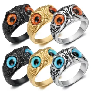 Detail view of owl eye stainless steel rings in black, gold, and silver finishes.