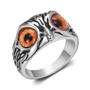 Close-up of vintage stainless steel ring featuring detailed owl eyes in gothic style