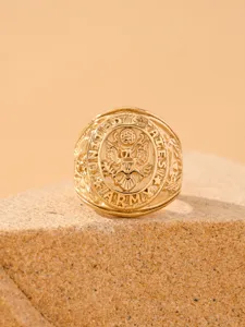 Close-up detail of retro gold stainless steel eagle relief military ring for men