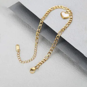 Close-up of 18K gold plated stainless steel heart anklet with cuban chain detail.