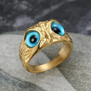Detailed view of vintage gold-plated stainless steel owl eye ring with blue stones
