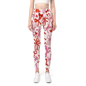 Detailed view of seamless high-waist yoga pants with red bow print and peach hip lift