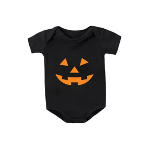 Detail view of baby black cotton onesie with orange jack-o'-lantern face for Halloween
