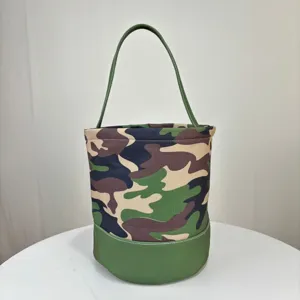 Detail view of camouflage canvas bucket bag with green base and sturdy long handle