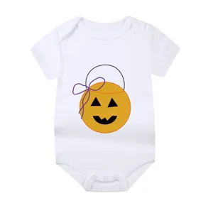 Detailed macro view of orange Halloween pumpkin print on white cotton baby bodysuit
