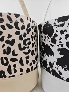 Close-up detail of leopard and cow print canvas candy baskets for Halloween party decor