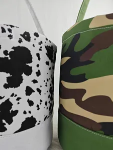 Close-up macro view of cow print and camouflage patterns on canvas Halloween candy bags.